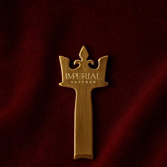 Imperial Saffron Royal Key in gold-tone metal displayed on burgundy velvet.
